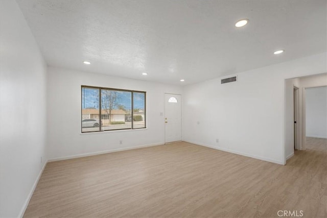 unfurnished room with light wood-type flooring