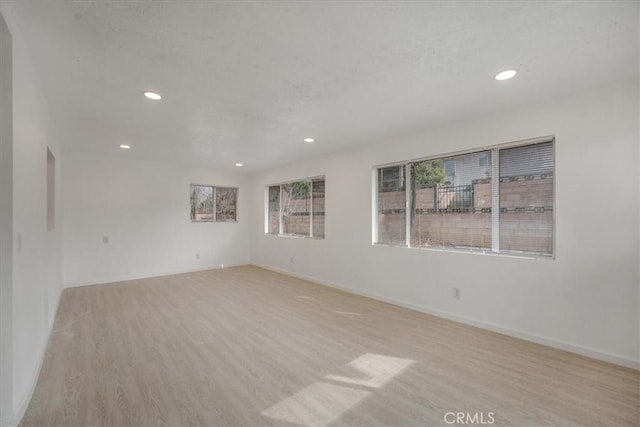 spare room with light hardwood / wood-style floors