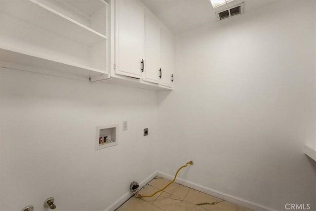 clothes washing area featuring hookup for a washing machine and cabinets