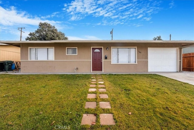 ranch-style house with a garage and a front lawn