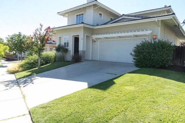 view of property featuring a front lawn and a garage