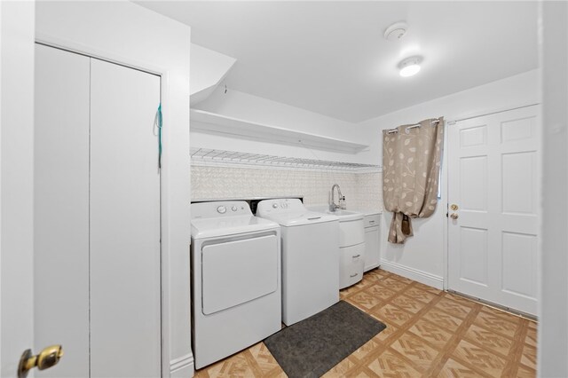 washroom with separate washer and dryer and cabinets