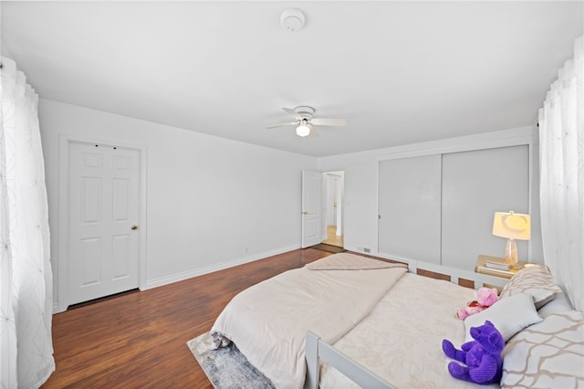 bedroom featuring ceiling fan, a closet, and dark hardwood / wood-style floors