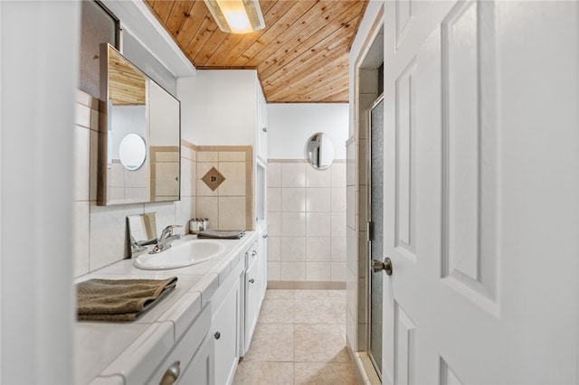 bathroom with vanity, wooden ceiling, tile patterned floors, tile walls, and an enclosed shower