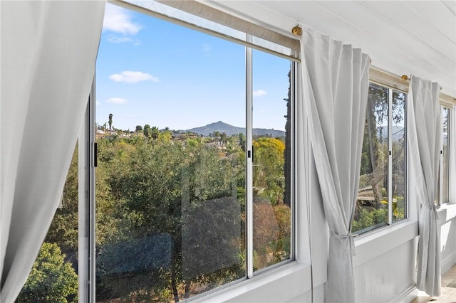 doorway with a mountain view and plenty of natural light