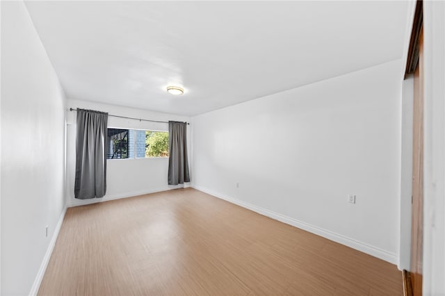 empty room with light hardwood / wood-style floors