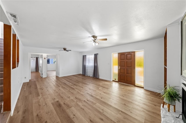 unfurnished living room featuring ceiling fan and light wood-type flooring