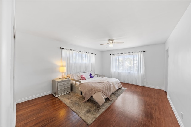 bedroom with dark hardwood / wood-style floors and ceiling fan