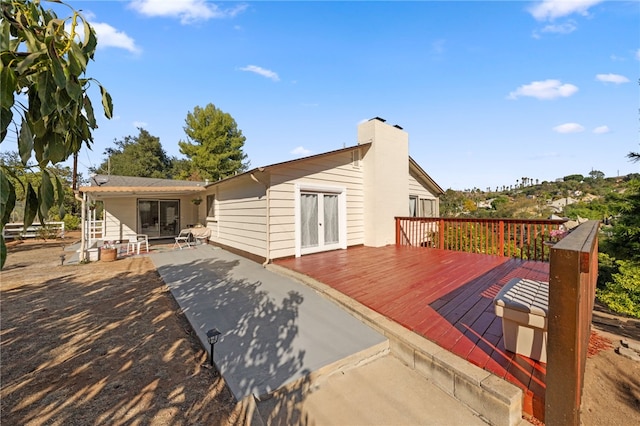 back of house featuring french doors and a deck