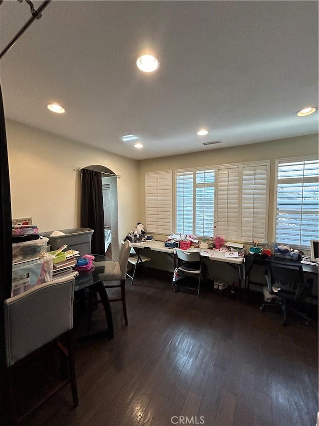 home office with dark hardwood / wood-style flooring