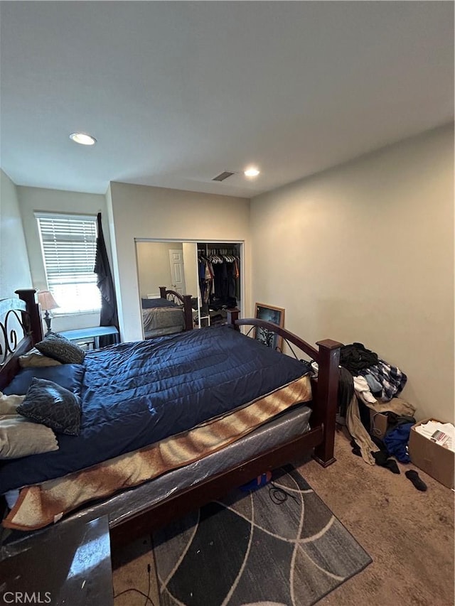 bedroom with carpet flooring and a closet