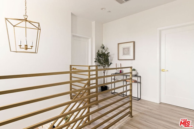 hallway with light hardwood / wood-style floors