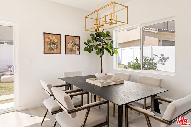 dining area with a notable chandelier and light wood-type flooring