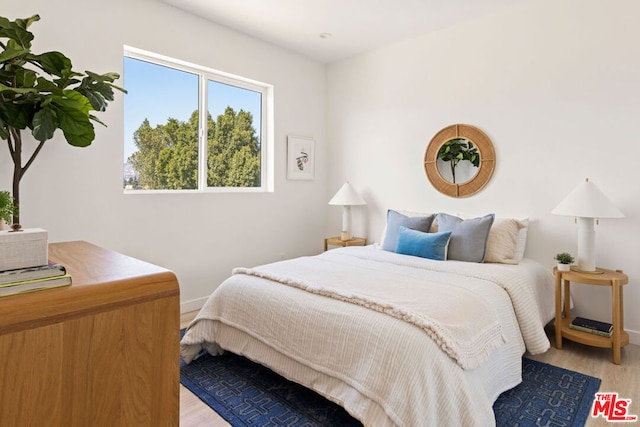 bedroom with light wood-type flooring