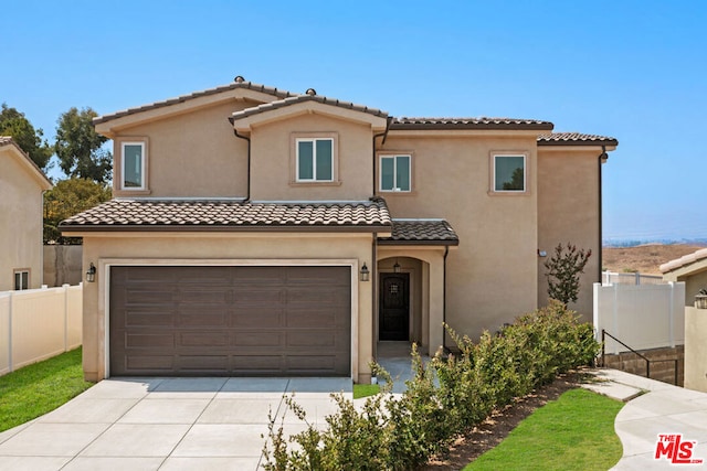 mediterranean / spanish-style house with a garage