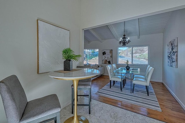 dining room with wooden ceiling, hardwood / wood-style floors, a notable chandelier, and vaulted ceiling with beams