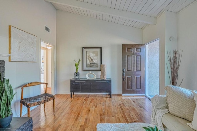 foyer with vaulted ceiling with beams and light hardwood / wood-style flooring