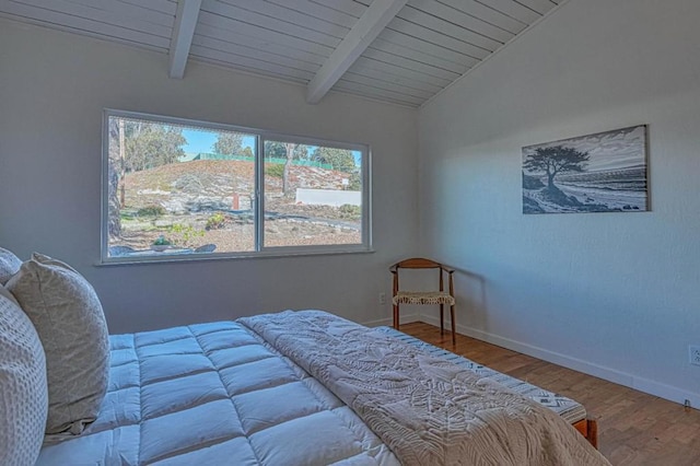 bedroom with hardwood / wood-style flooring, lofted ceiling with beams, and wood ceiling