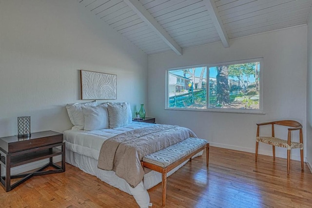 bedroom with wood ceiling, light hardwood / wood-style floors, and lofted ceiling with beams