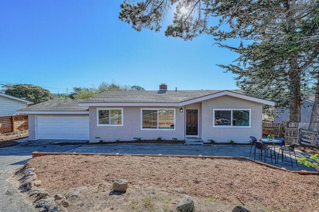 ranch-style house featuring a garage and a patio area