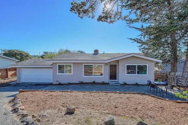 single story home with a garage and a patio area