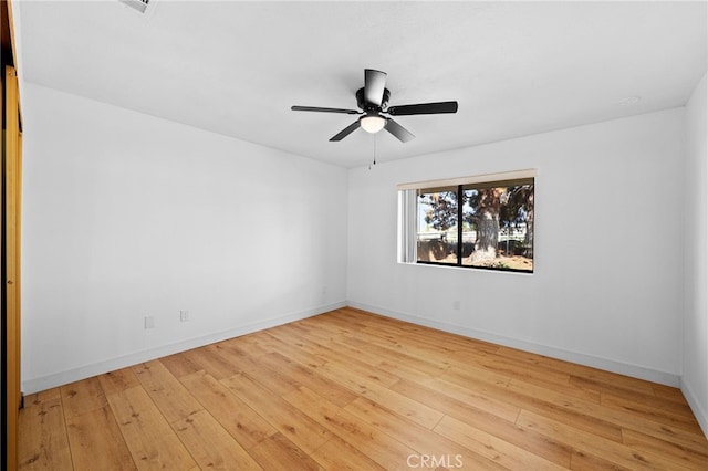 unfurnished room featuring light wood-type flooring and ceiling fan