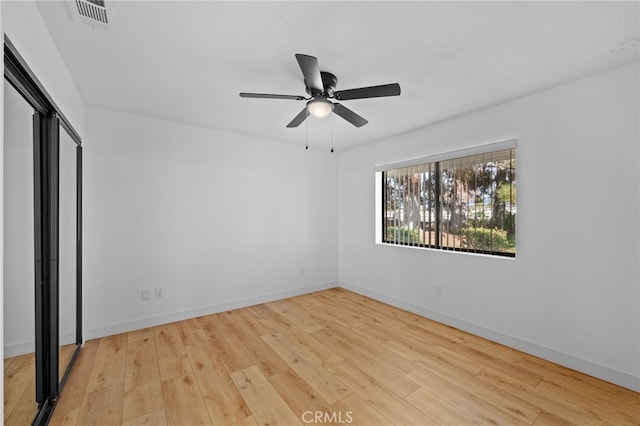 unfurnished bedroom with ceiling fan, a closet, and light hardwood / wood-style flooring