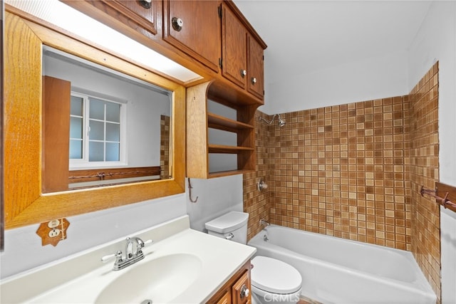 full bathroom featuring vanity, toilet, and tiled shower / bath