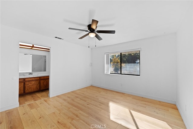 unfurnished room featuring ceiling fan and light hardwood / wood-style flooring