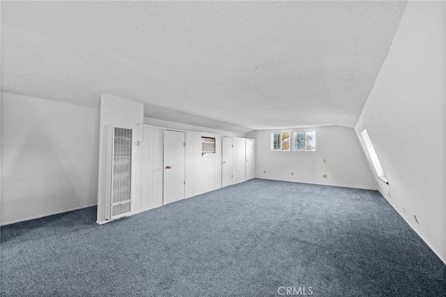 bonus room featuring carpet, a textured ceiling, and vaulted ceiling