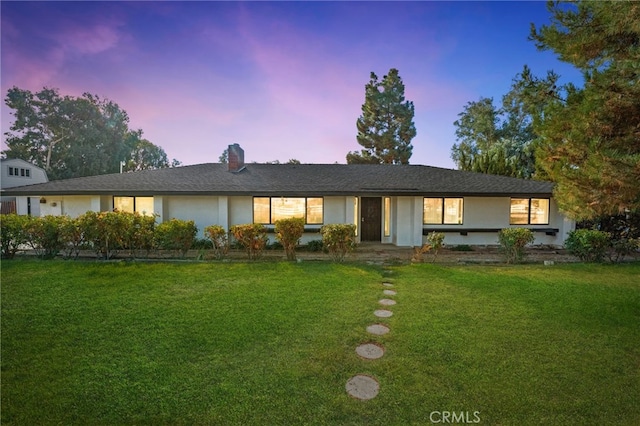 ranch-style house featuring a yard