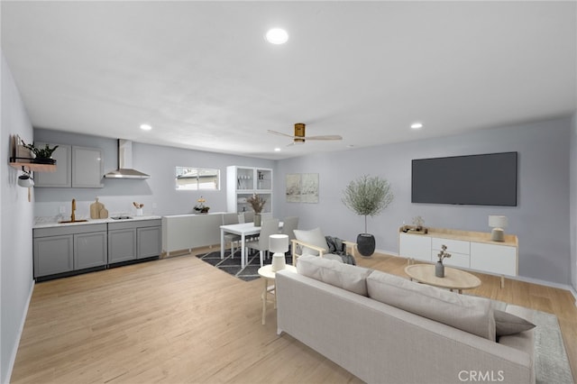 living room featuring light wood-type flooring and ceiling fan