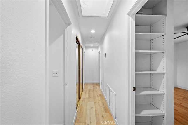 hall with light hardwood / wood-style flooring