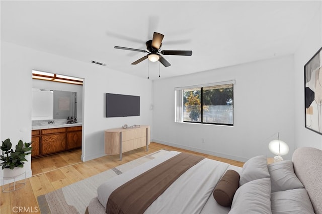 bedroom featuring ensuite bath, ceiling fan, and light hardwood / wood-style floors