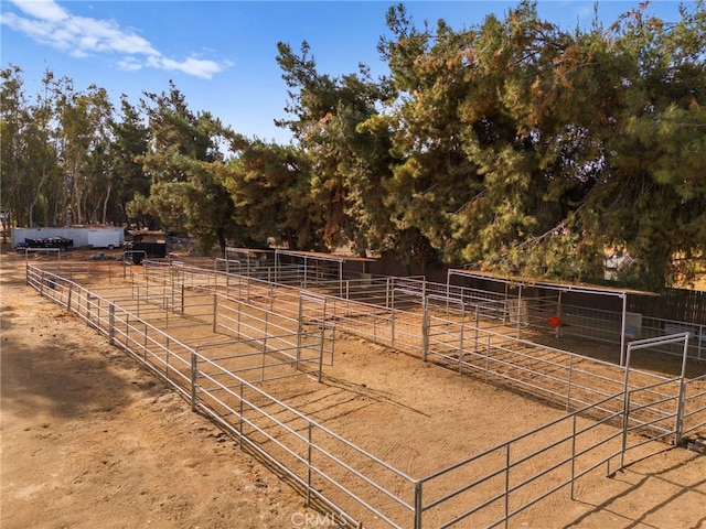 view of horse barn with a rural view