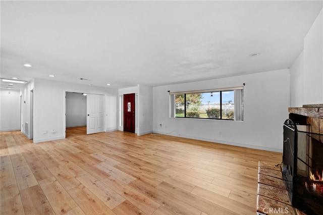 unfurnished living room featuring light wood-type flooring