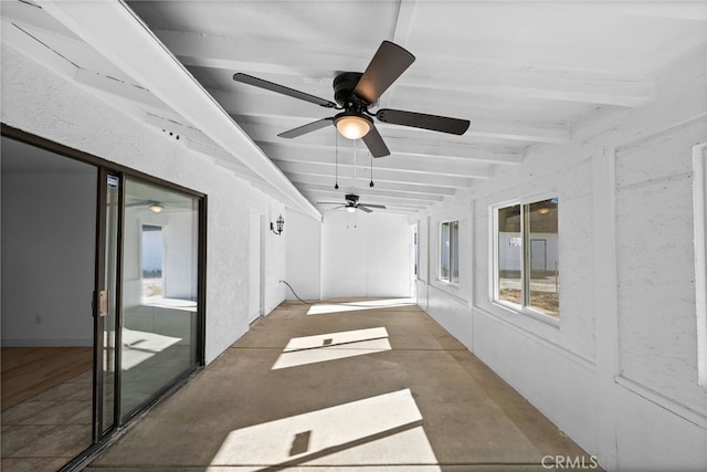 unfurnished sunroom with ceiling fan and lofted ceiling with beams