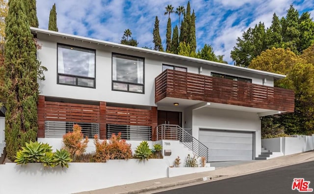 contemporary home featuring a garage and a balcony