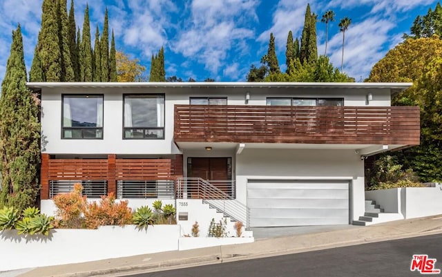 view of front of house with a balcony and a garage