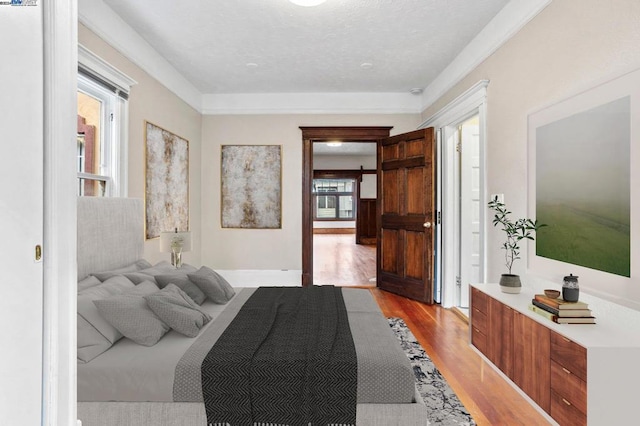 bedroom with a textured ceiling and light hardwood / wood-style floors