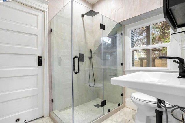 bathroom with toilet and a shower with shower door