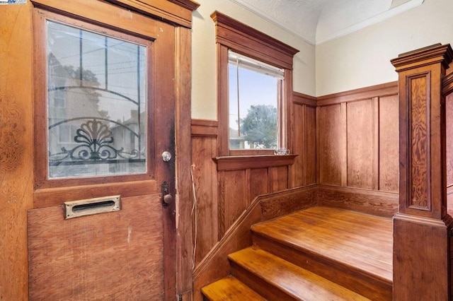 staircase featuring wood walls