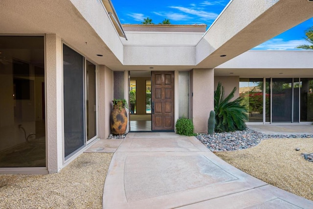 view of exterior entry featuring a patio