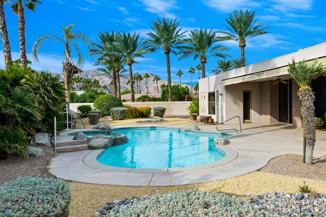 view of swimming pool featuring a patio area and an in ground hot tub