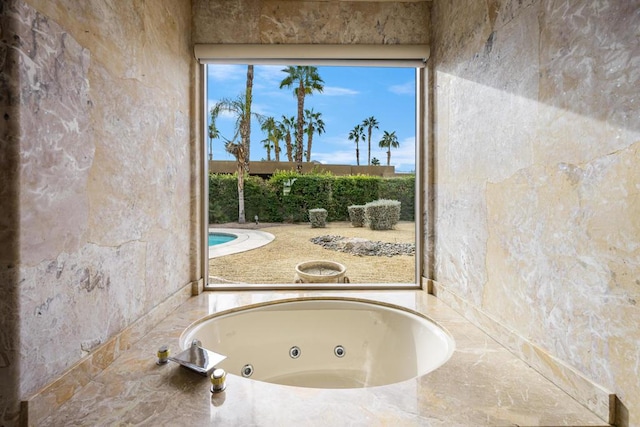 bathroom featuring a tub to relax in