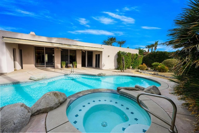 view of swimming pool featuring an in ground hot tub and a patio area