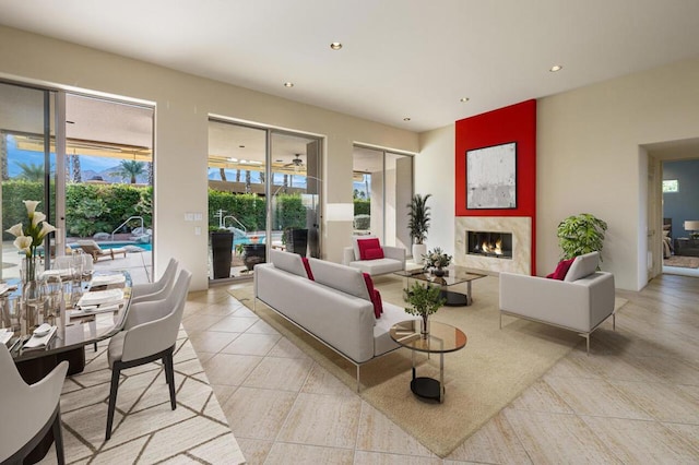 living room featuring a large fireplace and light tile patterned floors