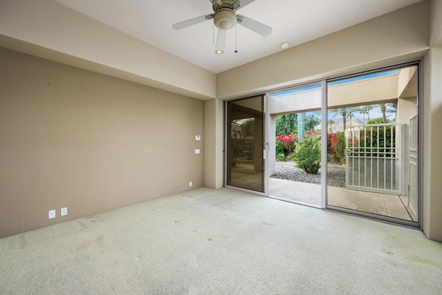 spare room featuring carpet and ceiling fan