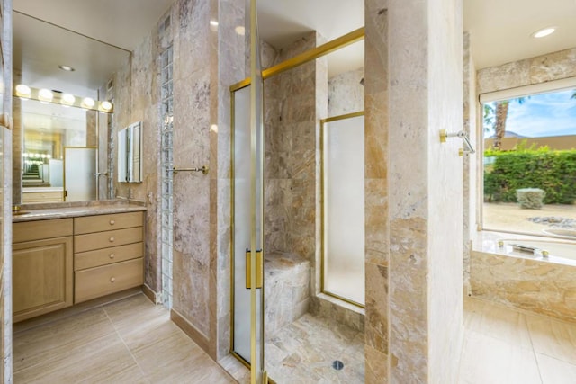 bathroom featuring vanity, a shower with shower door, and tile walls