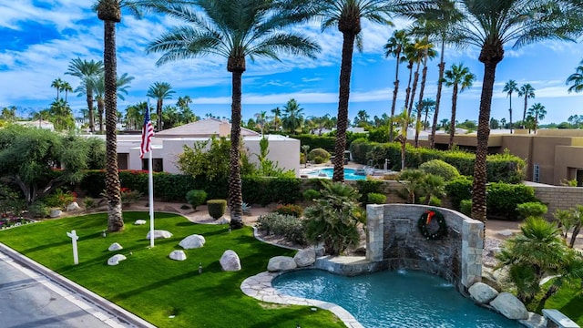 view of home's community with a lawn and a swimming pool